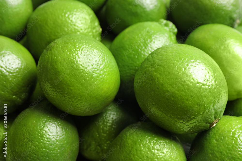 Fresh ripe green limes as background, closeup view Fresh ripe green limes as background, closeup view