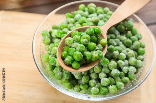 Frozen green peas on table, closeup. Vegetable preservation