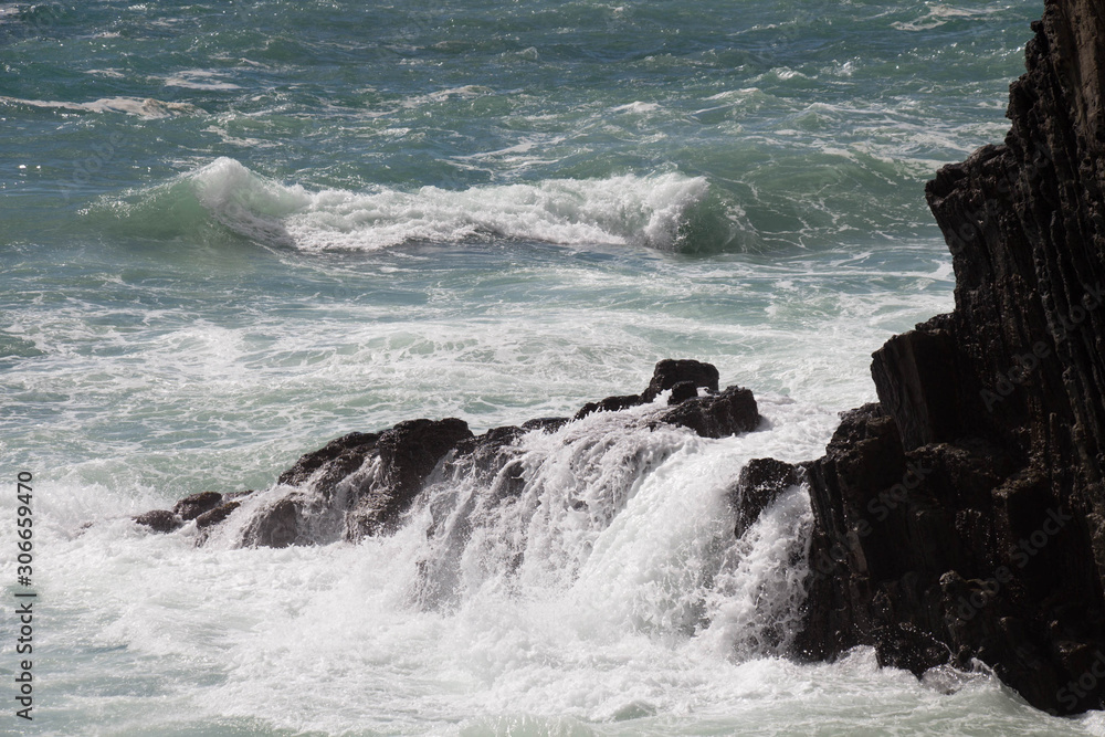 Waves are crashing on rocks. Marine Landscape. Waves are crashing on rocks. Marine Landscape.