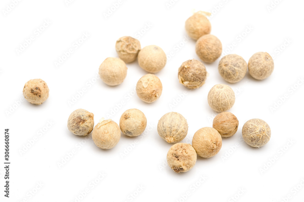 White peppercorn scattered on a white background. White peppercorn scattered on a white background.