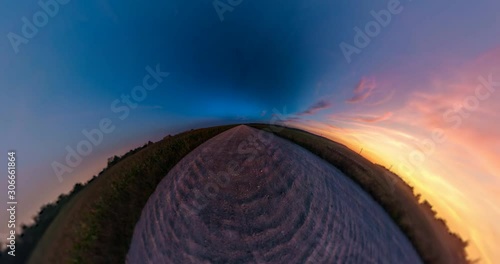Little planet Transformation with curvature of space. Abstract torsion and spinning of full flyby panorama among fields in sunny evening with awesome clouds.  