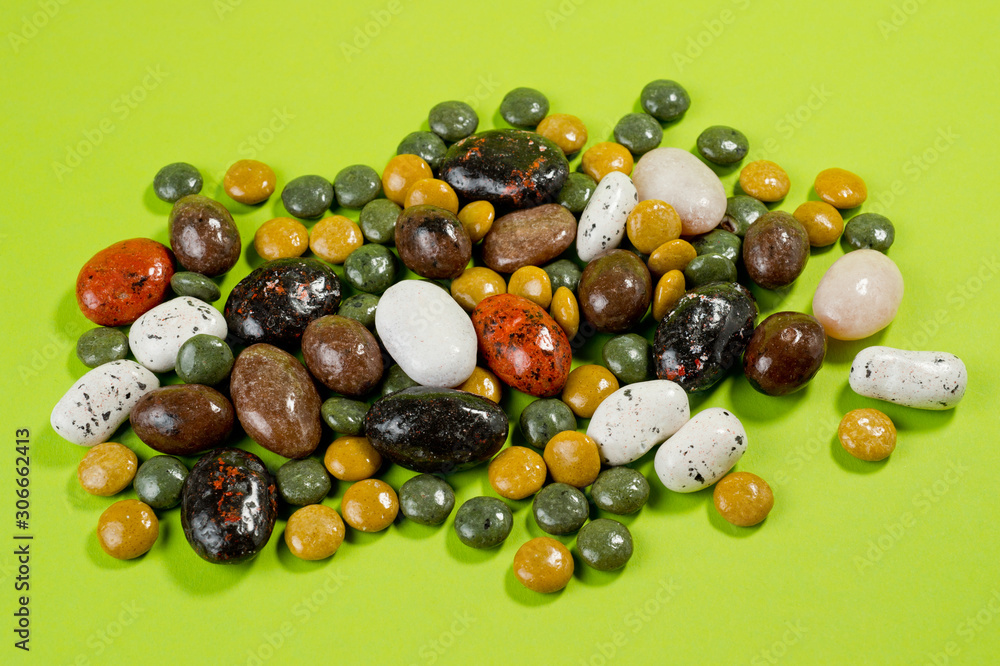 Pebble-dragee with apricots, chocolate, mandarin and marzipan. Tasty, bright, shot on a green background Pebble-dragee with apricots, chocolate, mandarin and marzipan. Tasty, bright, shot on a green background