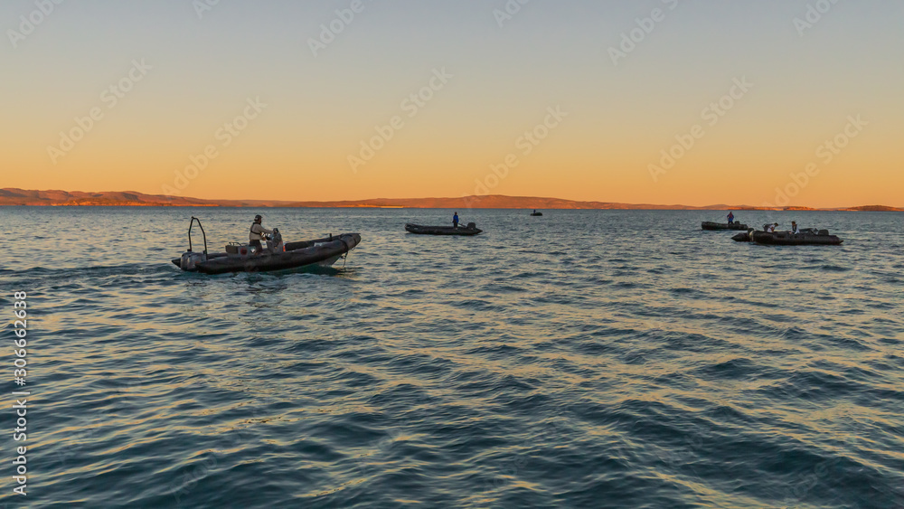 Zodiacs from a luxury expedition cruise ship anchored in Prince Frederick Harbor in the remote North West Kimberley wait to board guests for a shore excursion.