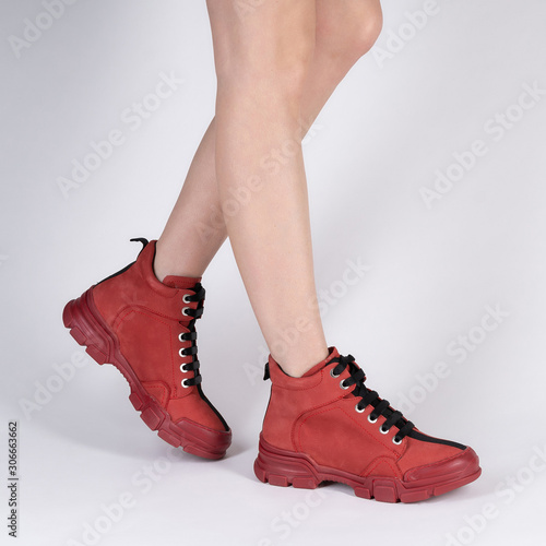 cool warm leather sneakers female colored model legs on a white background for a catalog