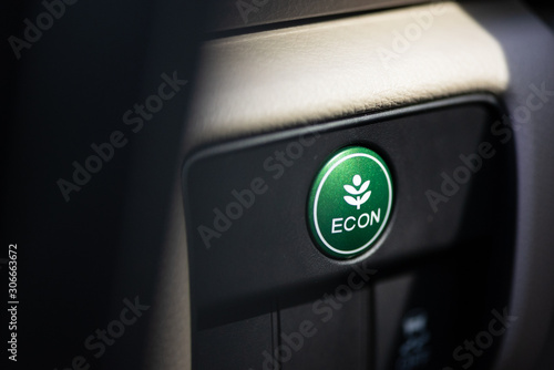 Green eco drive button in modern car. photo