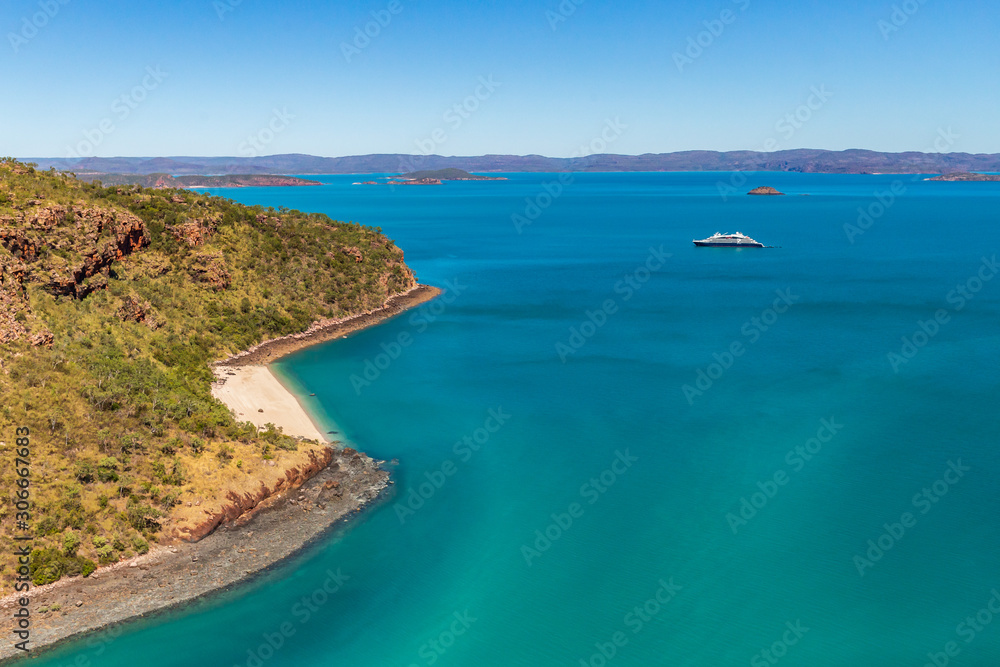 An luxury expedition cruise ship at anchor near Naturalist Island in Prince Frederick Harbor on the remote North West Coast of the Kimberley Region of Western Australia.