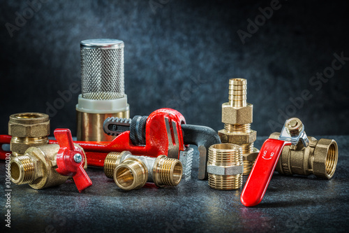 set of plumbing pipe connectors on dark background photo