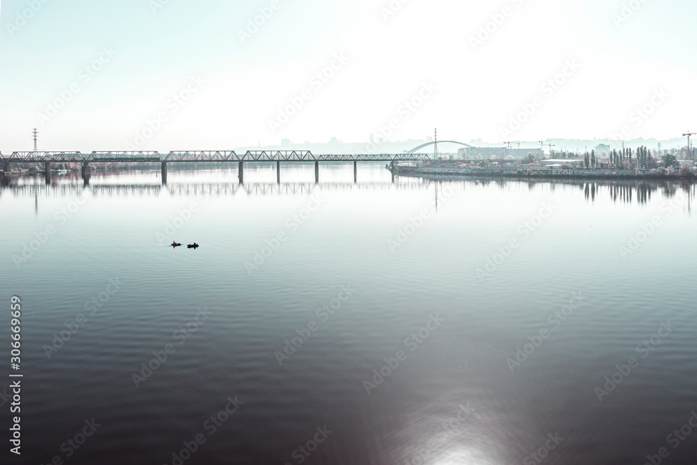 Morning foggy cityscape. The bridge over the Dnieper River, Kyiv