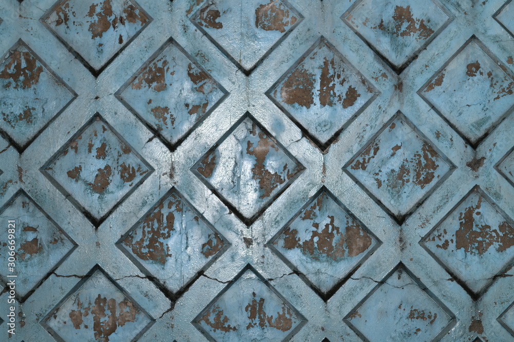 Texture of rhombus on the blue surface of a cement background with rust and smudges and scratches.