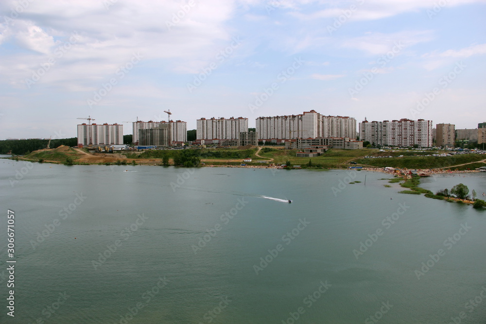 New houses on the other side of the pond. Photo