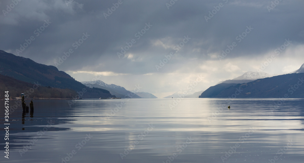 A view across Loch Ness looking down the length of the lake, with dark clouds above, in Scotland, UK