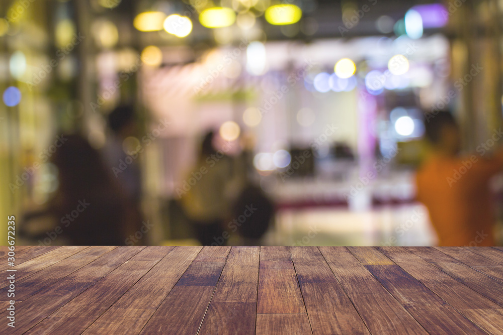 Blur cafe restaurant or coffee shop empty of dark wood table with blurred light gold bokeh abstract background for montage product display or design. Blur cafe restaurant or coffee shop empty of dark wood table with blurred light gold bokeh abstract background for montage product display or design.