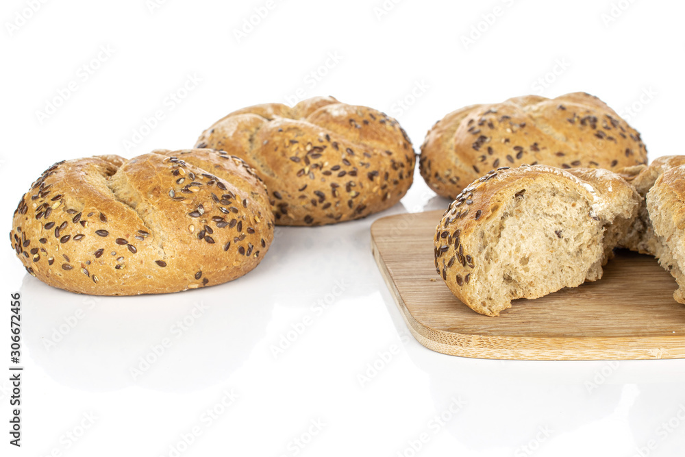 Group of three whole two halves of sesame kaiser roll on bamboo cutting board isolated on white background Group of three whole two halves of sesame kaiser roll on bamboo cutting board isolated on white background