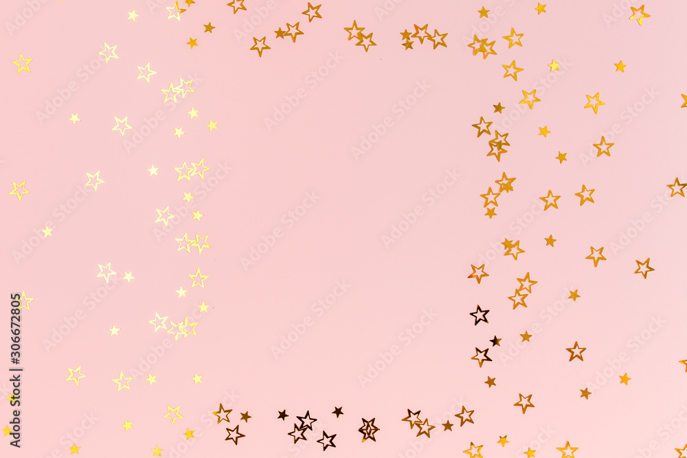 Photo frame mock up with space for text, golden confetti on a pink background. Colorful celebration, birthday background.Christmas or New Year pattern. Flat lay, top view 