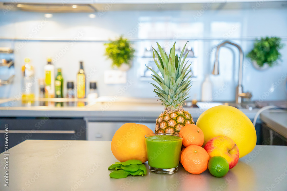 Different tropical fruits and smoothie on home kitchen background, healthy eating lifestyle concept Different tropical fruits and smoothie on home kitchen background, healthy eating lifestyle concept