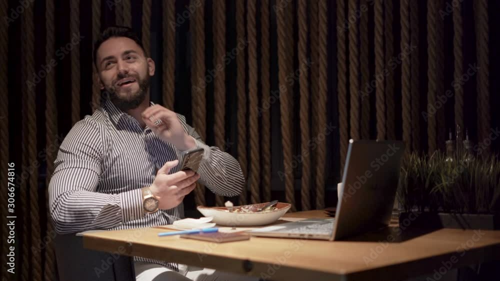 Good dressed businessman with black beard working on laptop at home or office Good dressed businessman with black beard working on laptop at home or office