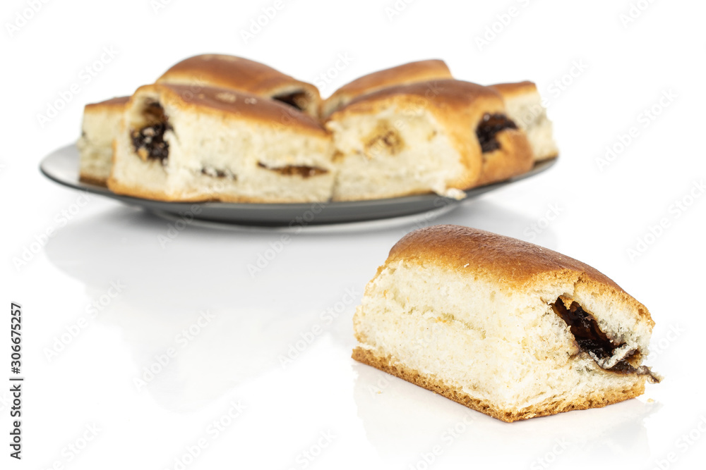 Lot of whole sweet czech bun front focus on gray ceramic plate isolated on white background Lot of whole sweet czech bun front focus on gray ceramic plate isolated on white background