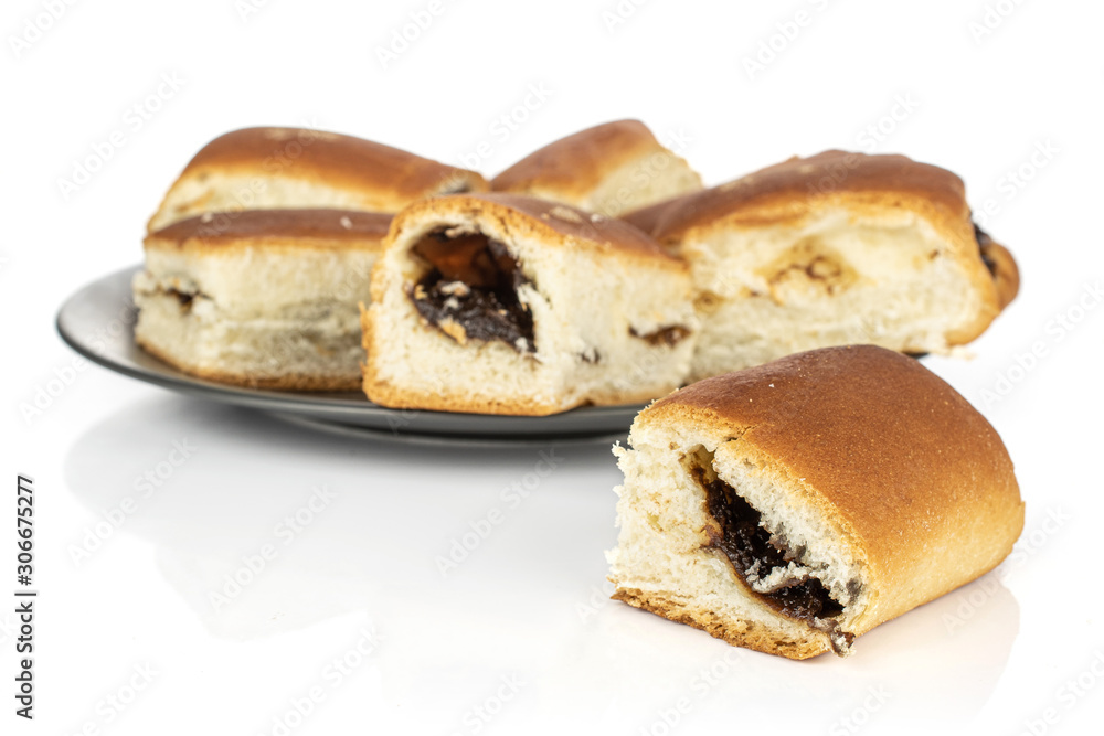 Lot of whole disordered sweet czech bun on gray ceramic plate isolated on white background