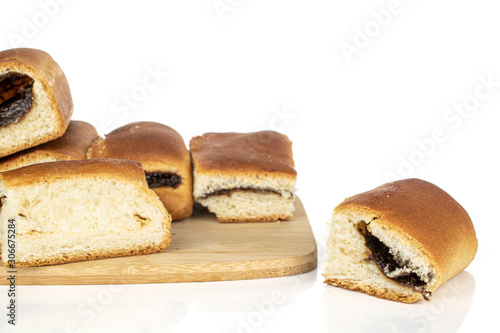 Lot of whole sweet czech bun on bamboo cutting board isolated on white background