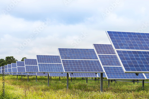 Close up rows array of polycrystalline silicon solar cells or photovoltaic cells in solar power plant turn up skyward absorb the sunlight from the sun 