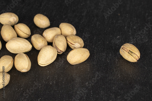 Lot of whole salted pistachio on grey stone photo