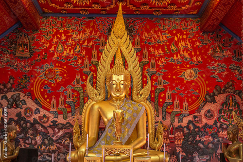 Public big golden buddha statue sitting in public thai temple at Wat Phra That Choeng Chum ,Sakon Nakhon ,Thailand