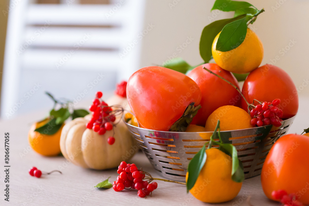 Food. Tangerines, viburnum, pumpkin, persimmon in table Food. Tangerines, viburnum, pumpkin, persimmon in table