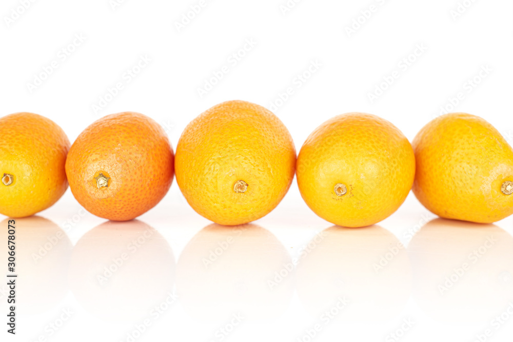 Group of five whole tasty orange kumquat isolated on white background Group of five whole tasty orange kumquat isolated on white background