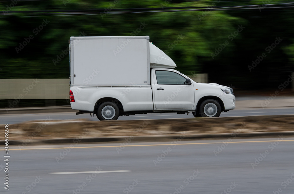 Motion on the road,small white truck for logistics business.