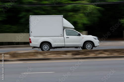 Motion on the road,small white truck for logistics business.