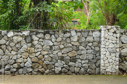 Beautiful stone fence with garden house