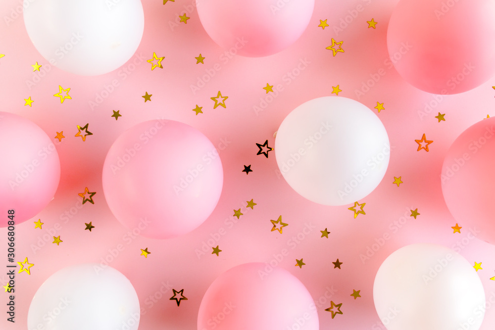 Balloons and confetti on pink background. Valentines day, Birthday, holiday concept. Flat lay, top view