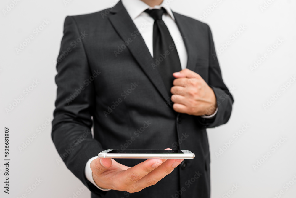 Male human wear formal work suit hold smart hi tech smartphone use one hand Male human wear formal work suit hold smart hi tech smartphone use one hand