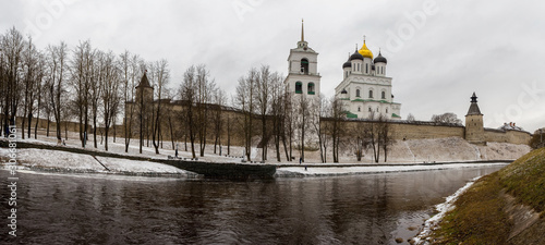 The ancient medieval fortress is located on the river Bank. The fortress is covered with fallen snow. Pskov, Russia.