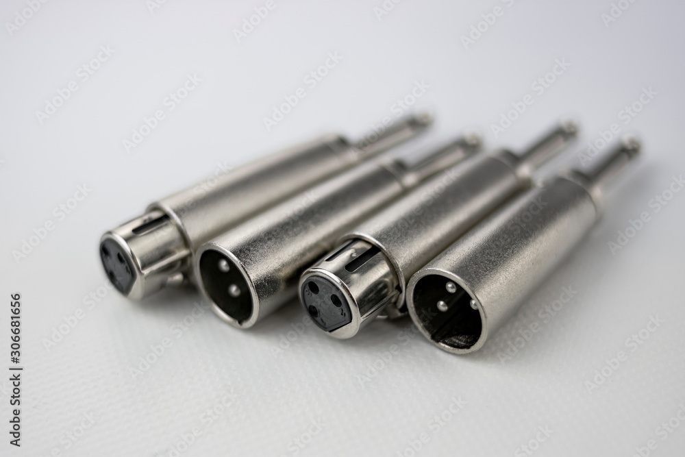 Close-up of male and female xlr inputs or outputs in audio converters with mono jack terminal on white background Close-up of male and female xlr inputs or outputs in audio converters with mono jack terminal on white background