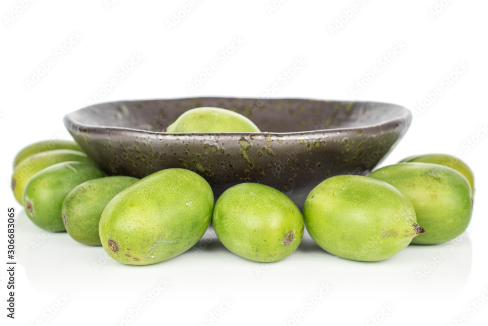 Lot of whole hardy green kiwi in glazed bowl isolated on white background Lot of whole hardy green kiwi in glazed bowl isolated on white background