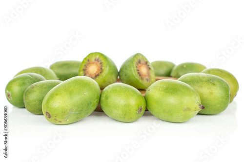 Group of lot of whole two halves of hardy green kiwi isolated on white background