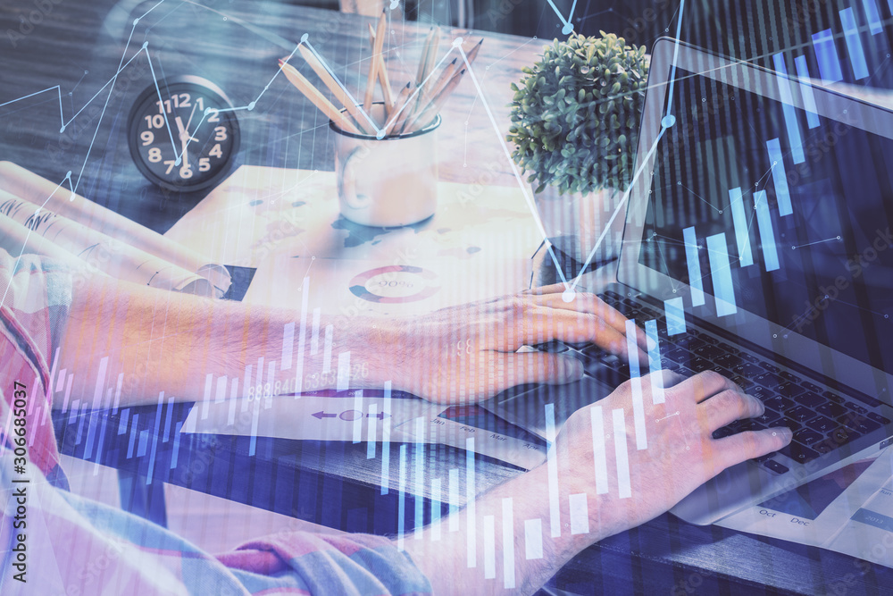 Double exposure of stock graph with businessman typing on computer in office on background. Concept of hard work. Double exposure of stock graph with businessman typing on computer in office on background. Concept of hard work.