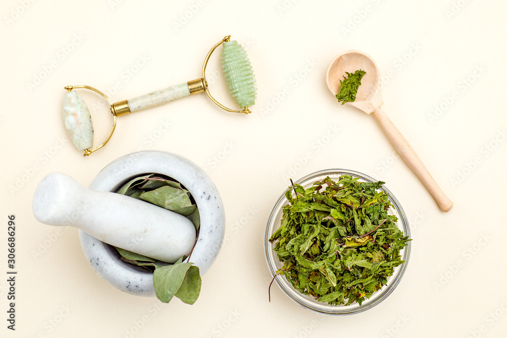 Dried herbs and face roller. Organic skin care. Sustainable lifestyle. Dried herbs and face roller. Organic skin care. Sustainable lifestyle.