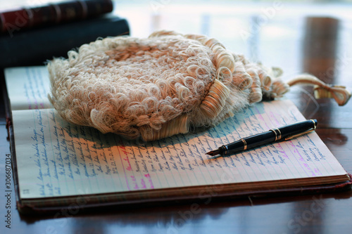 Wig and pen with journal entry in front of window