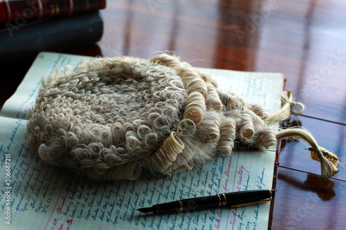 Barrister’s wig on notebook on table in front of window