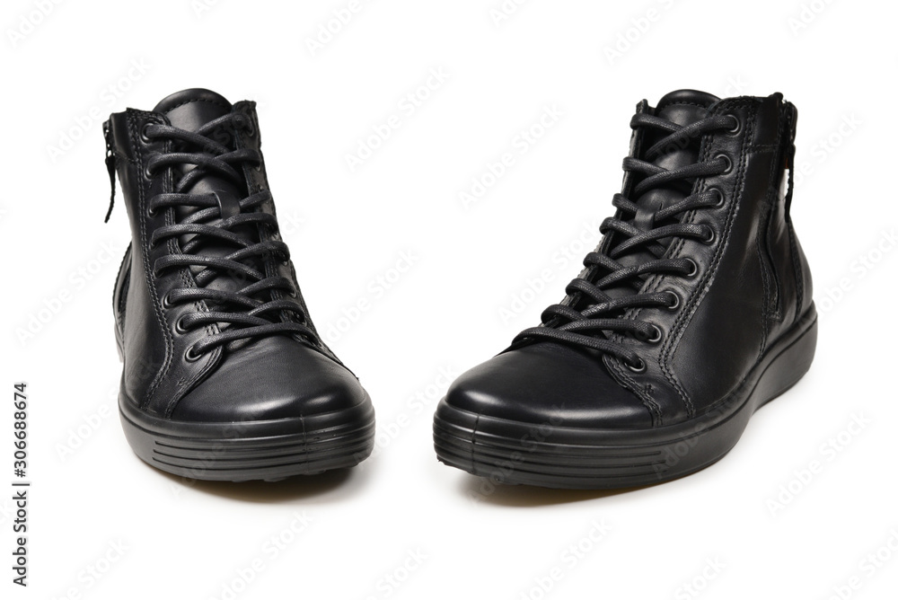 Men's black leather shoes and a black camera on a isolated on white background. Copy space.