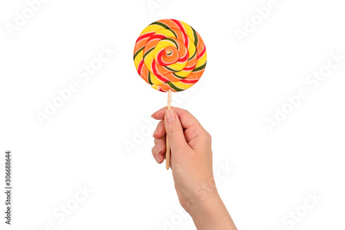 Lollipop in female hand isolated on white background. Space for text or design.
