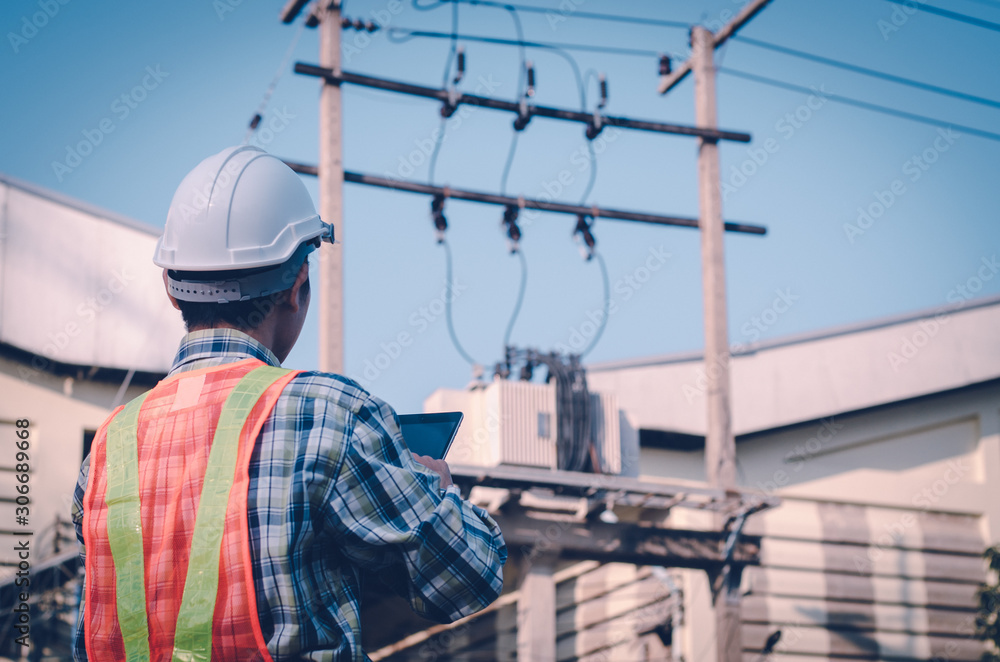 Electrical engineer holding and using a digital tablet Electrical engineer holding and using a digital tablet