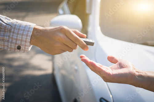 man who is picking up the smart key with his hand