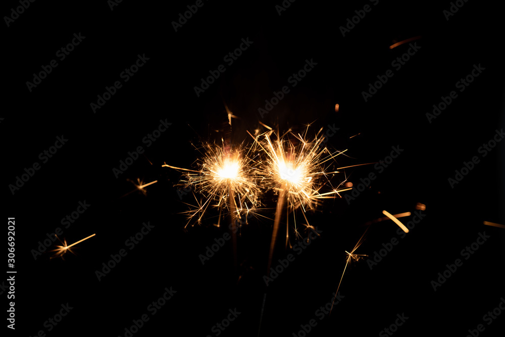 Firework sparkler burning isolated black background.