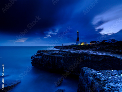 Portland Bill Light house with a stormy sunset
