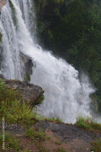 Close up of the water falls of Cherrapunjee Eco park with lots of trees and greenery of the hills, selective focusing