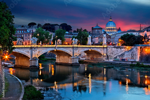 ROME, ITALY . Ponte Vittorio Emanuele II and Tiber river, as seen from Ponte Sant'Angelo. In the background the dome of St Peter's Basilica.
