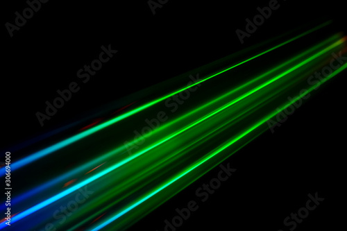 Beams of light refracting and creating a rainbow spectrum of colours against a black background